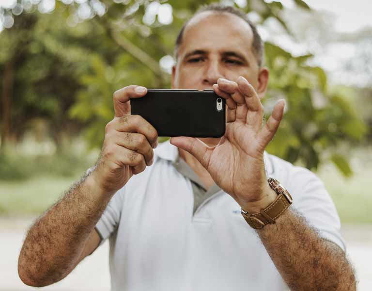 A man hold the mobile phone camera with steady